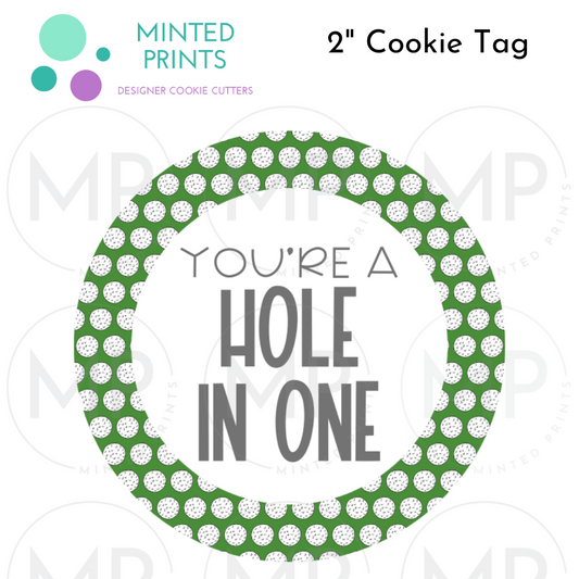 You're A Hole in One 2" Cookie Tag with Golf Balls Background
